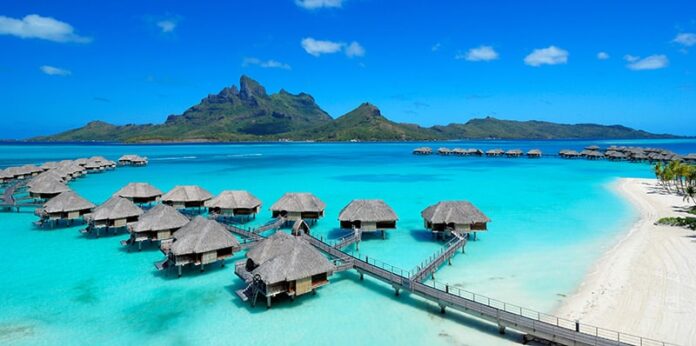 Four Seasons Resort Bora Bora with overwater bungalows and Mt Otemanu in the background.