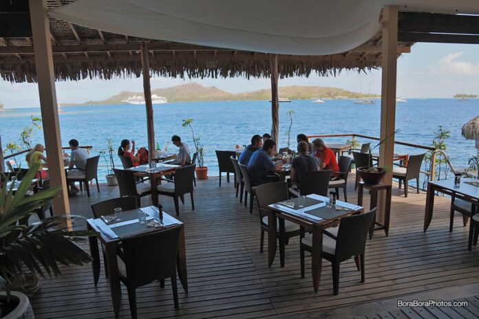 Beautiful blue lagoon view with overwater patio at the Saint James restaurant.