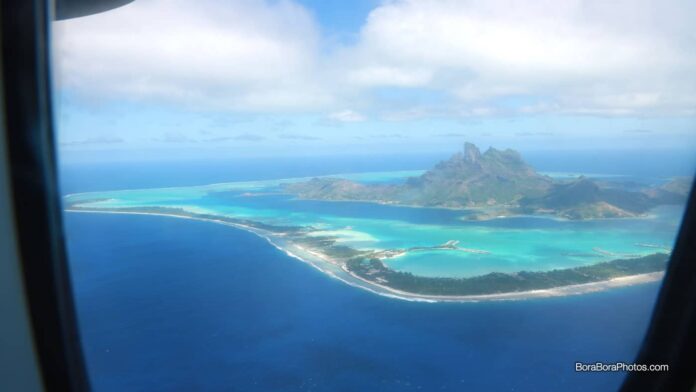 View of Bora Bora island from a plane window.