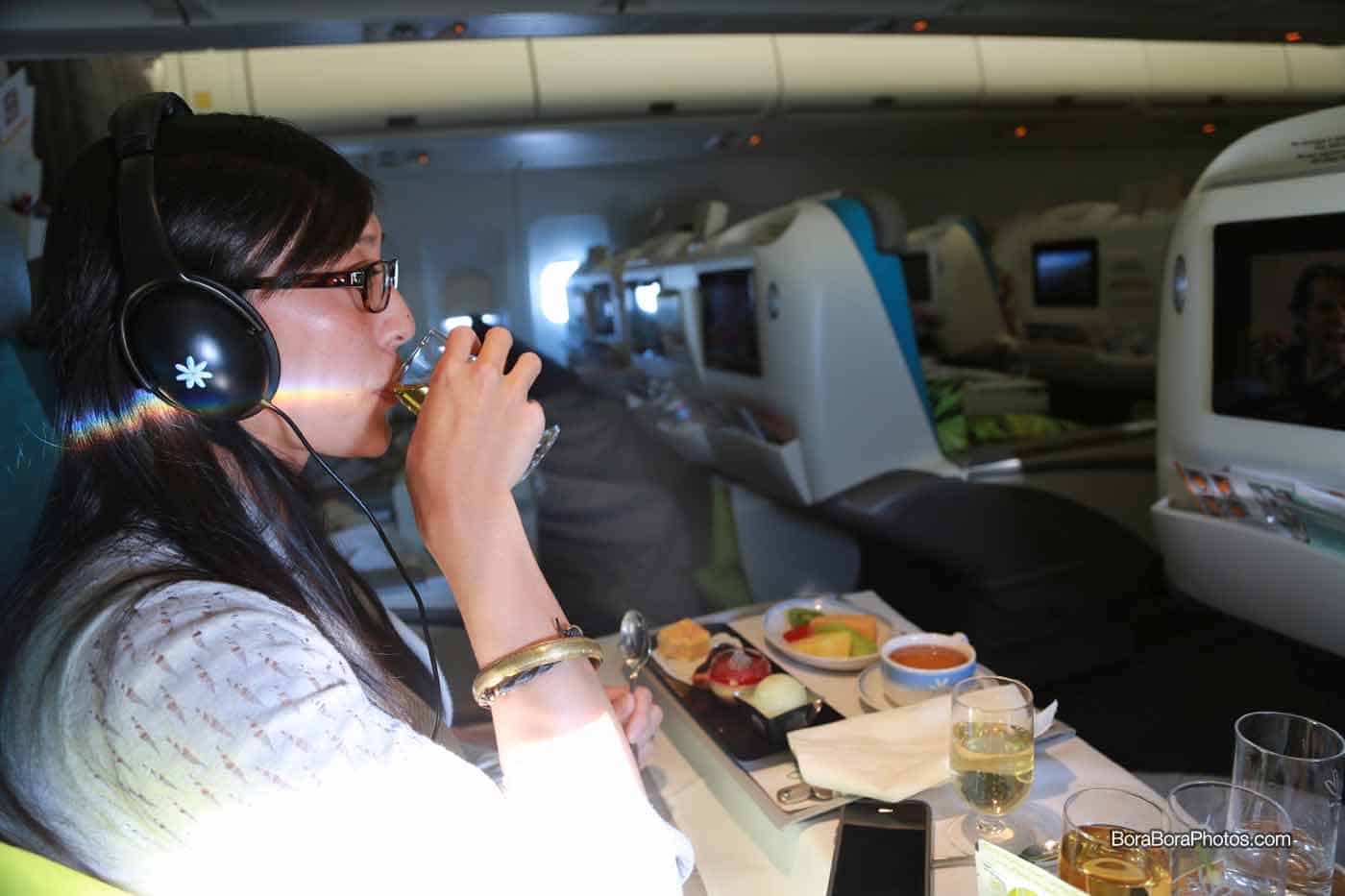 Jessica wearing Air Tahiti Nui provided headphones to watch a movie.